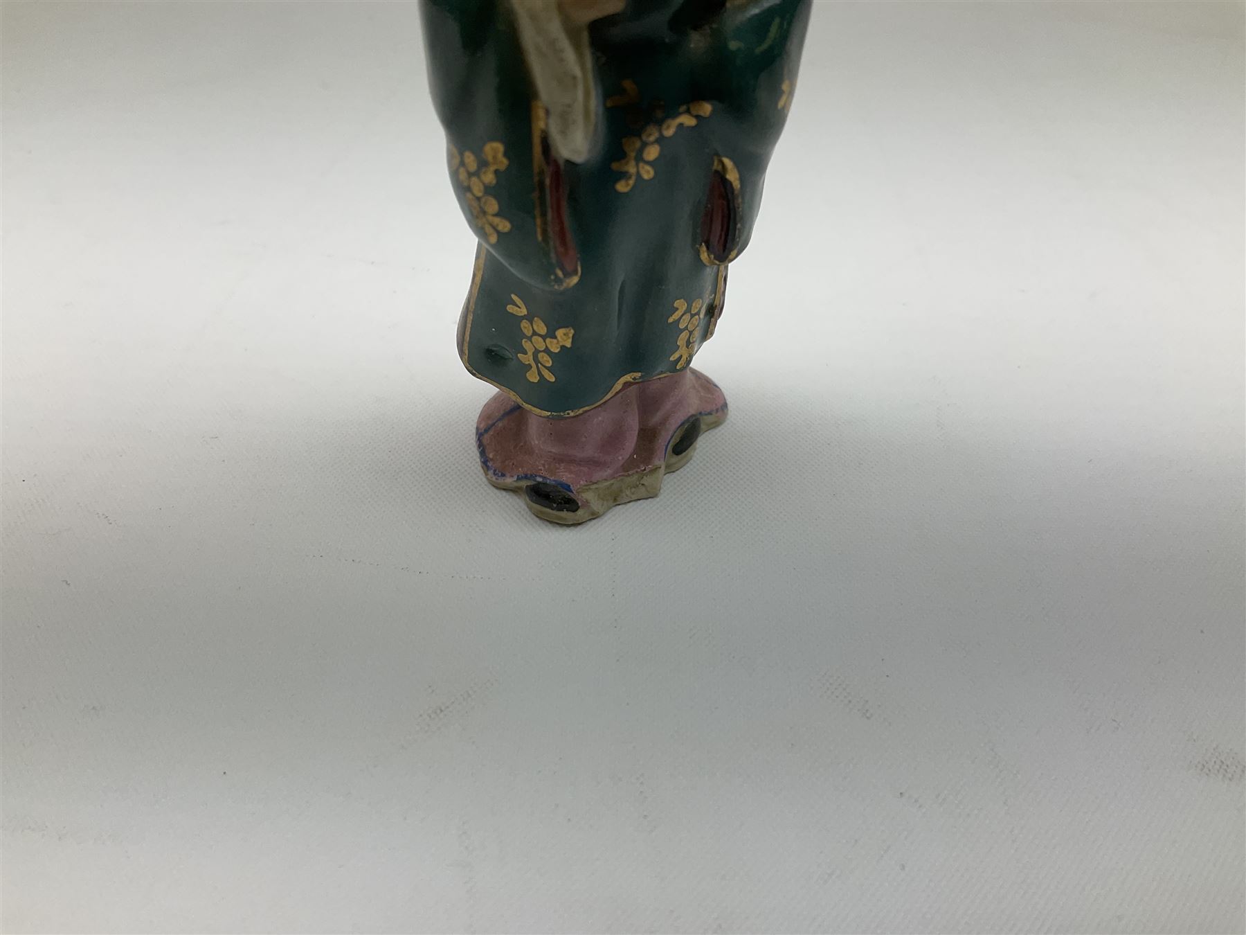 Japanese parquetry puzzle box L12cm; another Japanese puzzle box with marquetry top of Mount Fuji; eleven graduated Chinese figures including immortals; and Chinese figure of a lady standing on a hardwood base next to a horn table (14)