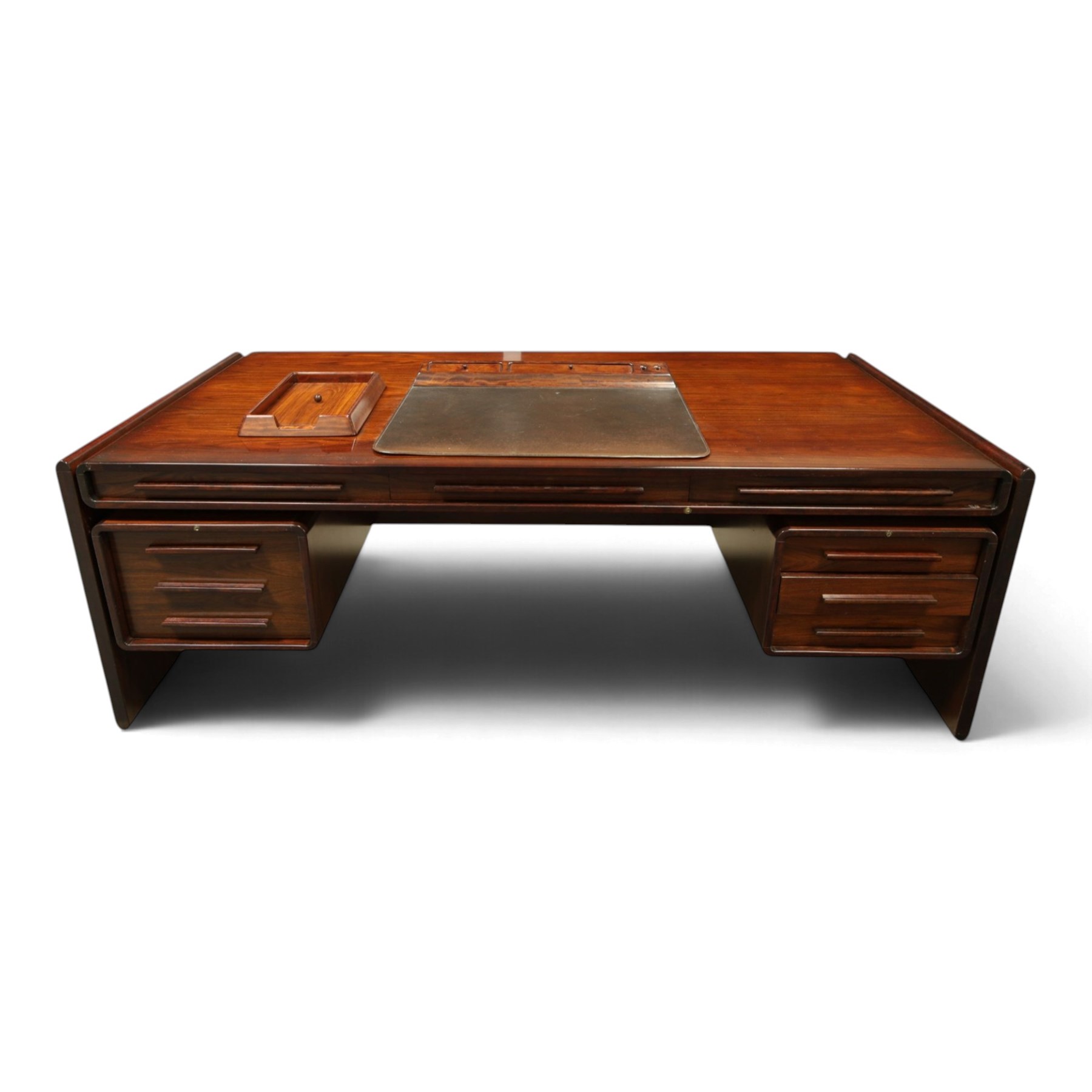 Dyrlund - Santos rosewood office suite, comprising an executive desk and cream leather upholstered swivel chair, the desk with a broad rectangular top with rounded corners, leather writing surface, pen compartments and letter tray, three lockable frieze drawers with fitted interiors above a central kneehole flanked by floating drawer pedestals, the left housing a filing drawer and the right three compartmented drawers, with a full width modesty panel to the reverse, chair raised on a castor base, H 116cm, W 62cm, D 74cm