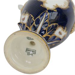 Late 19th century Royal Worcester porcelain vase and cover, circa 1897, of baluster form with twin lion masks to shoulders, painted with a reserve of exotic birds within a landscape, against a blue scale ground with gilt highlights, and further detailed with smaller reserves containing butterflies, the shoulder, base of body and foot with moulded acanthus bands, upon a circular spreading foot, with green printed marks beneath including shape number 2305 and Rd no 419210, H27.5cm