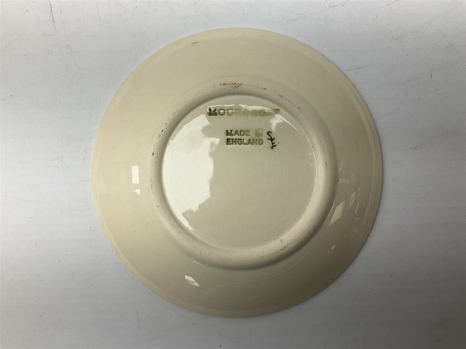 Moorcroft pin dish decorated in the Pink Magnolia pattern on a cream ground, D12cm