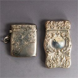 Two silver vesta cases, comprising an American silver example with embossed foliate decora...