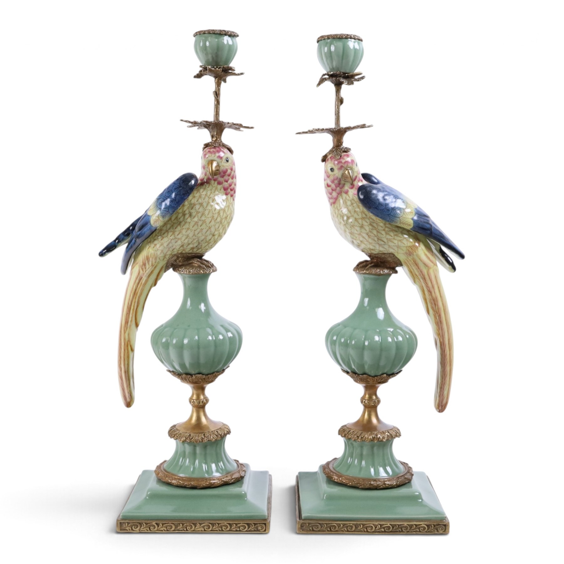 Pair candlesticks, modelled as parrots, upon urn shaped mounts with gilt detail, H48cm