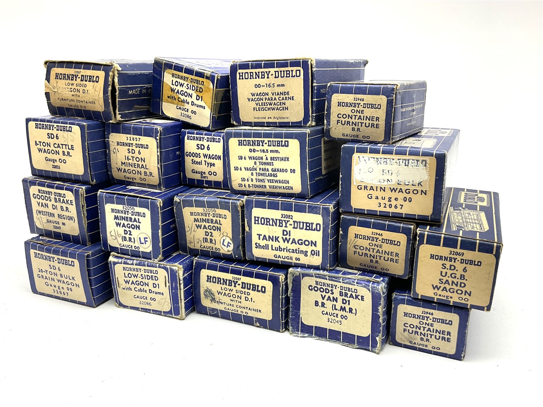 Hornby Dublo - twenty wagons including Cattle Trucks; Low-Sided Wagons; Cable Drum Wagons; Tank Wagon for Shell Lubricating Oil; Mineral Wagons; 20-Ton Bulk Grain Wagons; Goods Brake Vans; Furniture Containers etc; all in blue striped boxes (20)
