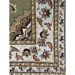 Turkish Sincerity Royale green ground rug, the field decorated with a central floral medallion surrounded by scrolling floral motifs in shades of cream, beige, and burgundy, spandrels filled with matching floral designs, the border featuring a series of floral patterns on a cream ground, finished with green edges
