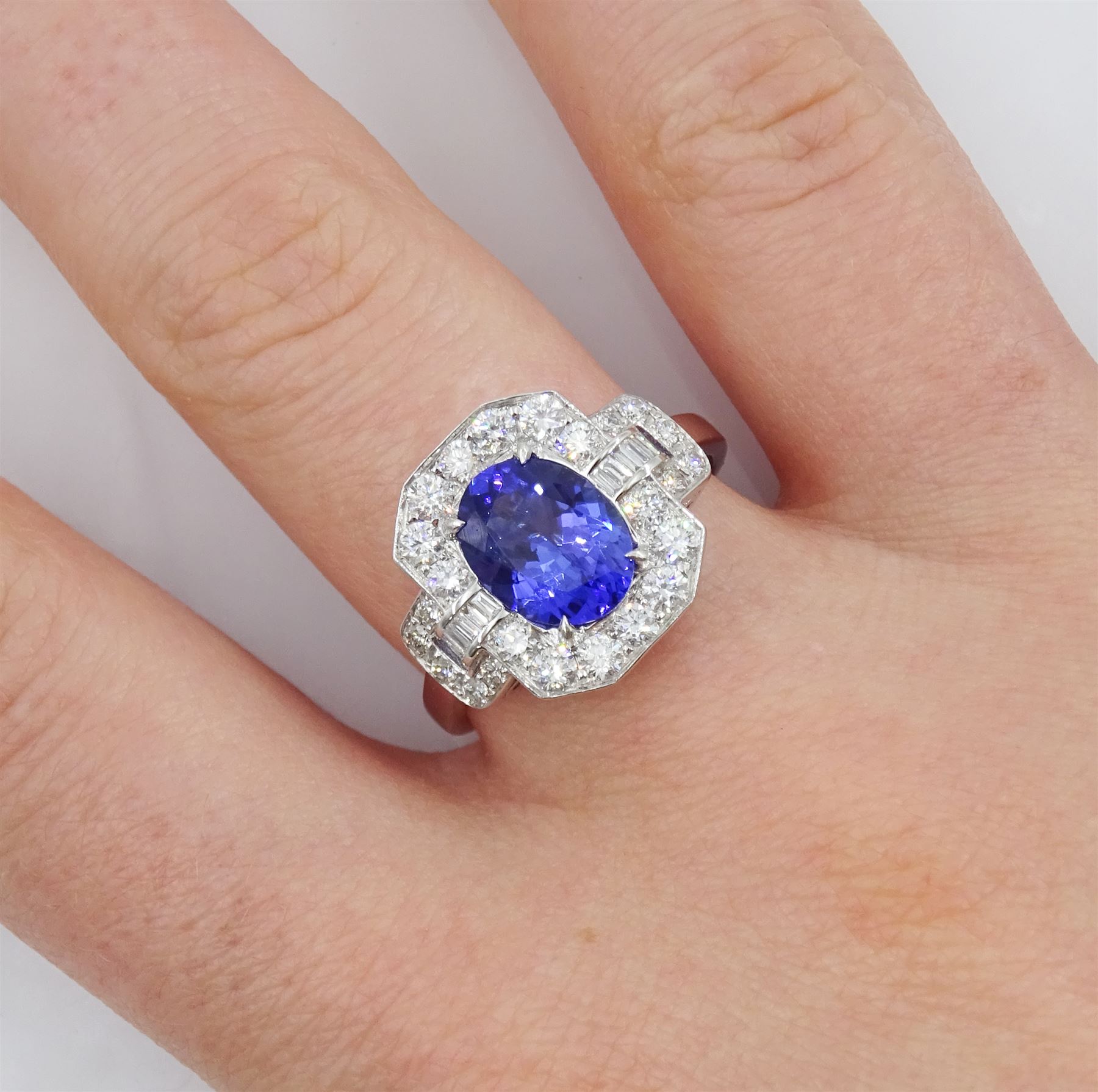 18ct gold oval tanzanite, round and baguette cut diamond cluster ring, stamped 750, tanzanite approx 1.85 carat, total diamond weight approx 0.70 carat