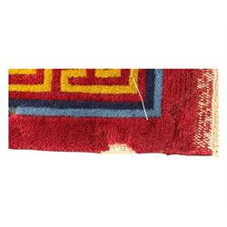 Tibetan-design handwoven rug, deep red field with three central medallions in yellow and blue, traditional yellow key border, white fringes on both ends