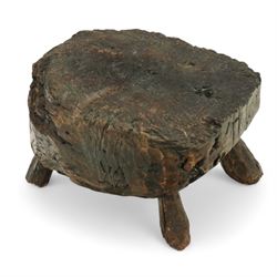 Rustic bog oak stool of oval form with a single solid section with a deeply patinated and ...