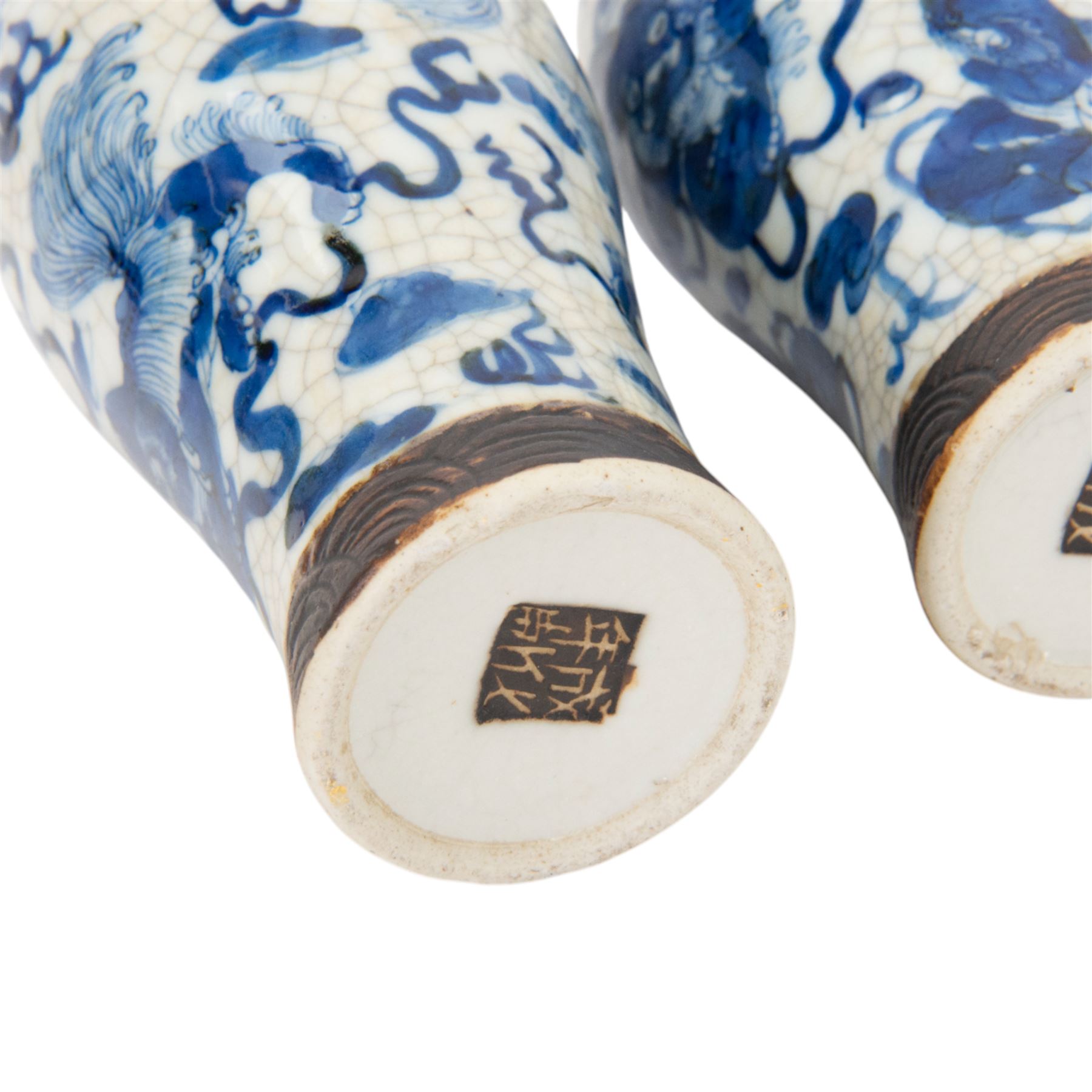 Pair of 20th century Chinese crackle glaze vases, of baluster form, decorated with dogs of foo amongst clouds, H23cm