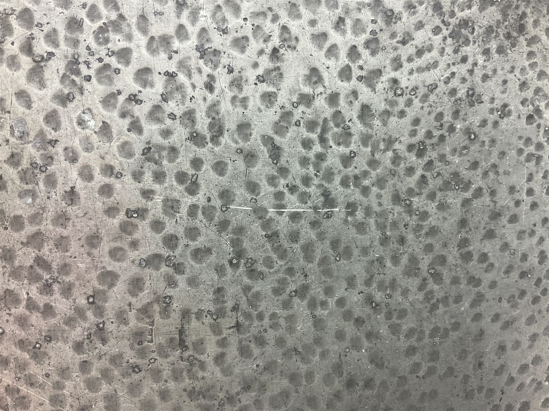 Arts and Crafts oak stand by Arthur Simpson of Kendal, of rectangular form with central hammered pewter panel, surrounded by a border with carved foliate corners, upon two bar supports, bearing label detailed 