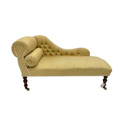 Small Victorian style chaise longue, upholstered in gold lozenge patterned fabric, on turned feet with brass castors