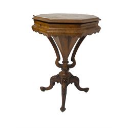 Victorian walnut work or sewing table, octagonal form with hinged lid, upholstered and fitted interior, on four plain and shaped supports with central trumpet, on four splayed and foliate carved supports