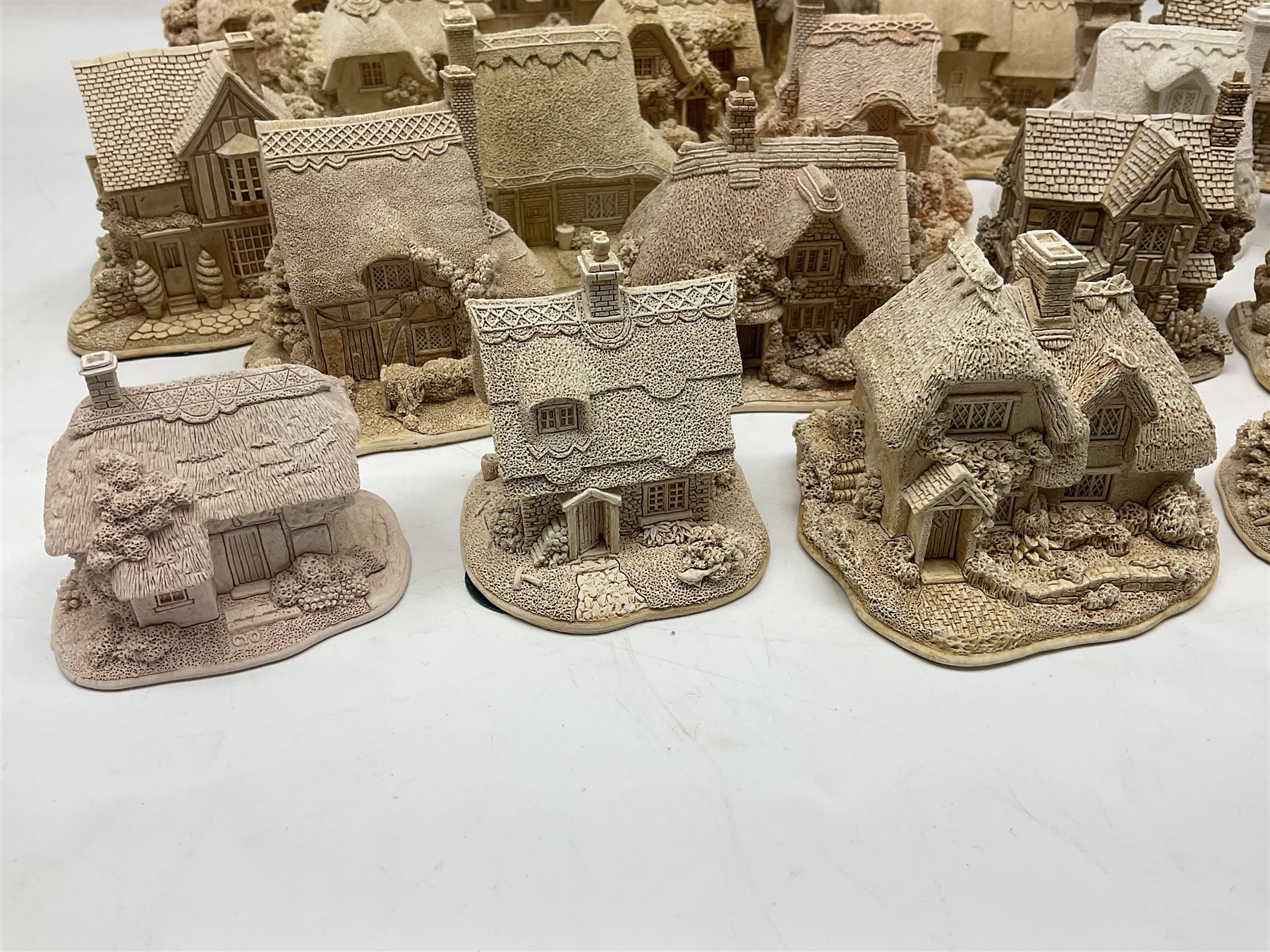 Twenty-three Lilliput Lane models from the Paint Your Own collection, to include Catmint Cottage, Sugar and Spice, Gypsy Cottage, Ruby Cottage and Little Birch, some boxed