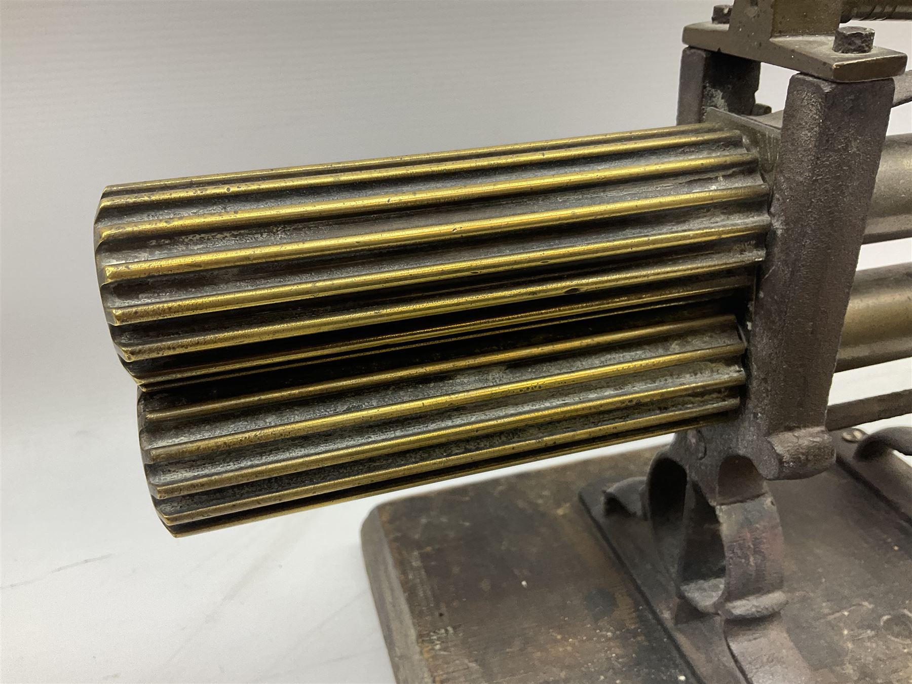 Victorian cuff and collar tabletop mangle, the ribbed brass rollers in a cast iron frame mounted on a wooden base