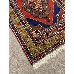 Turkish Taspinar rug, blue ground with central lozenge and medallion, the outer borders decorated with stylised motifs
