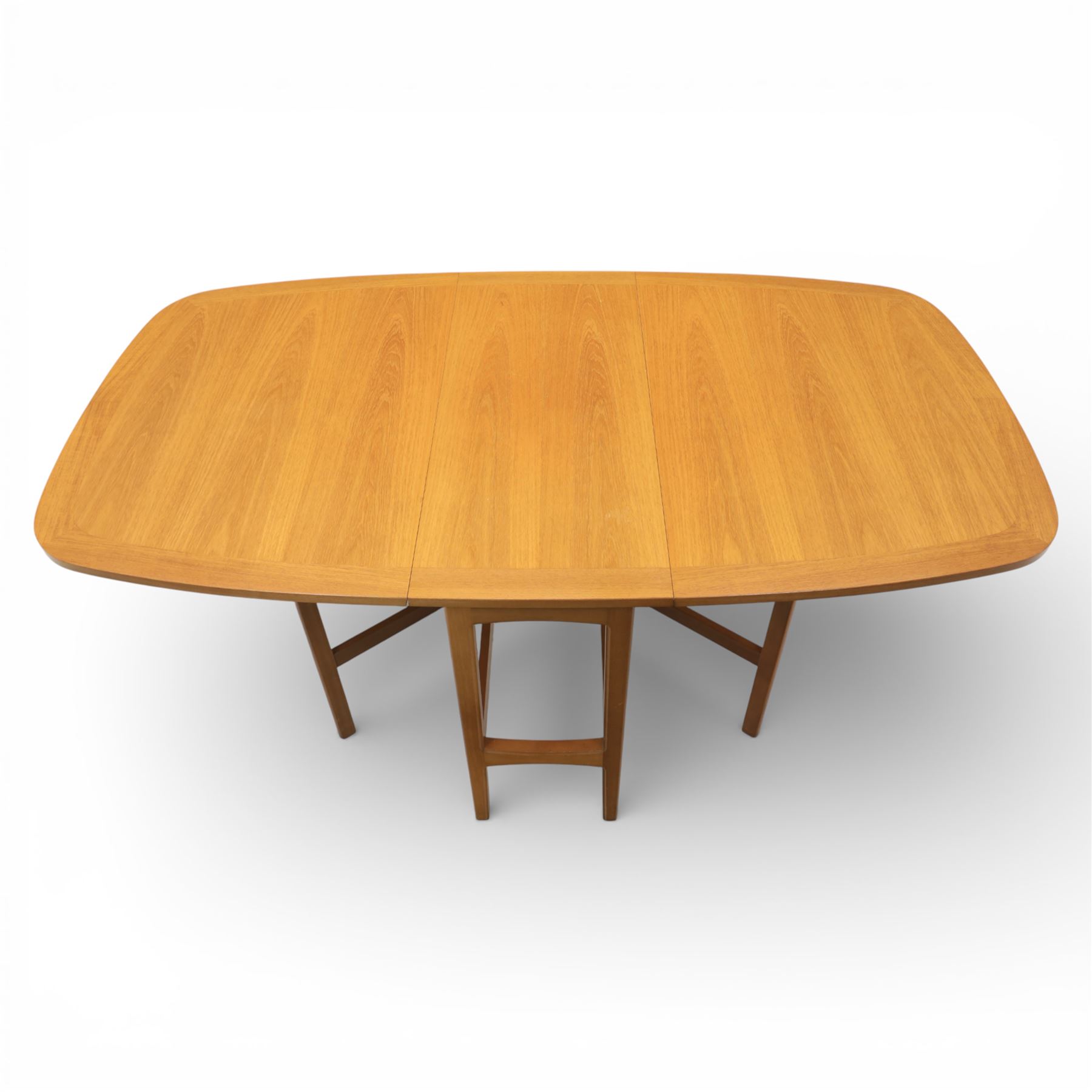 Nathan - teak drop leaf dining table, the rectangular top with rounded corners fitted with twin hinged drop leaves and gate legs, extended to form an oval table 174cm in length, raised on square section supports united by stretchers
