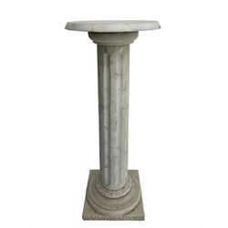 Classical design white granite pedestal, the circular plinth over a fluted column with a carved egg and dart collar, the turned circular base terminating in a square plinth with reeded edge