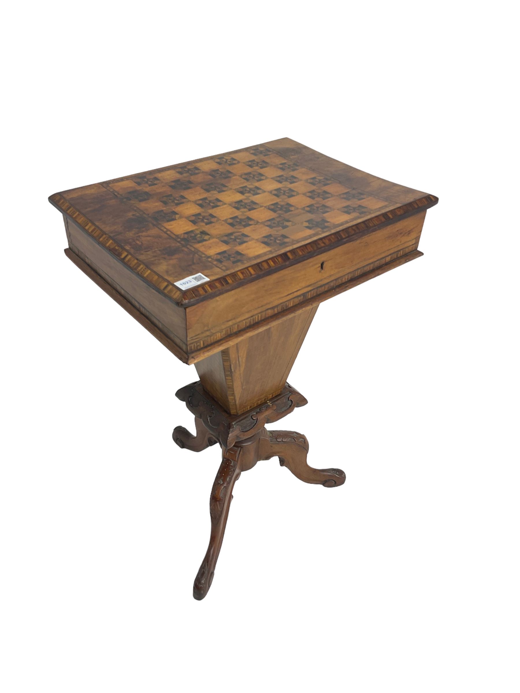 Victorian walnut work table, the rectangular hinged top inlaid with a chessboard design, canted edge with alternating ebony and satinwood inlays, concealing fitted interior, banded and strung frieze over tapering column well, collar carved with foliate decoration, on a cabriole tripod base