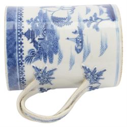 Large 18th century Chinese export blue and white tankard, of cylindrical form with foliate mounted strap handle, the body painted with a riverside landscape with pagodas, willows and pine trees, beneath a cell and spear head band to rim, H14cm D10.5cm