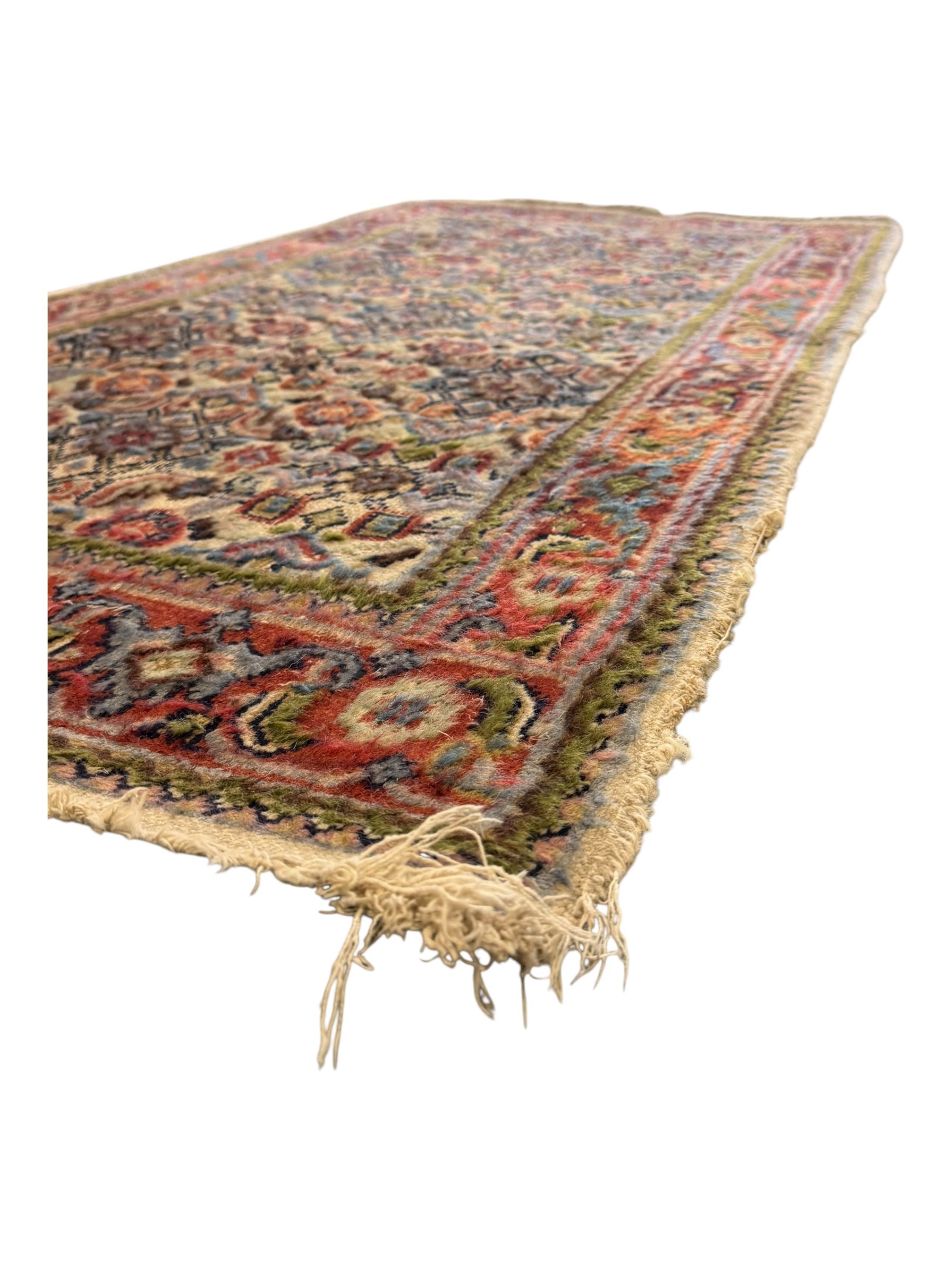 Persian-style wool rug, cream field with floral and geometric motifs, wide floral border (74cm x 142cm); Persian wool rug, beige field with dense floral patterns, narrow floral border (70cm x 144cm); Tribal wool rug, red and navy with diamond motifs (96cm x 60cm); Persian pictorial wool rug, black field with vase, birds, and floral border (70cm x 73cm)