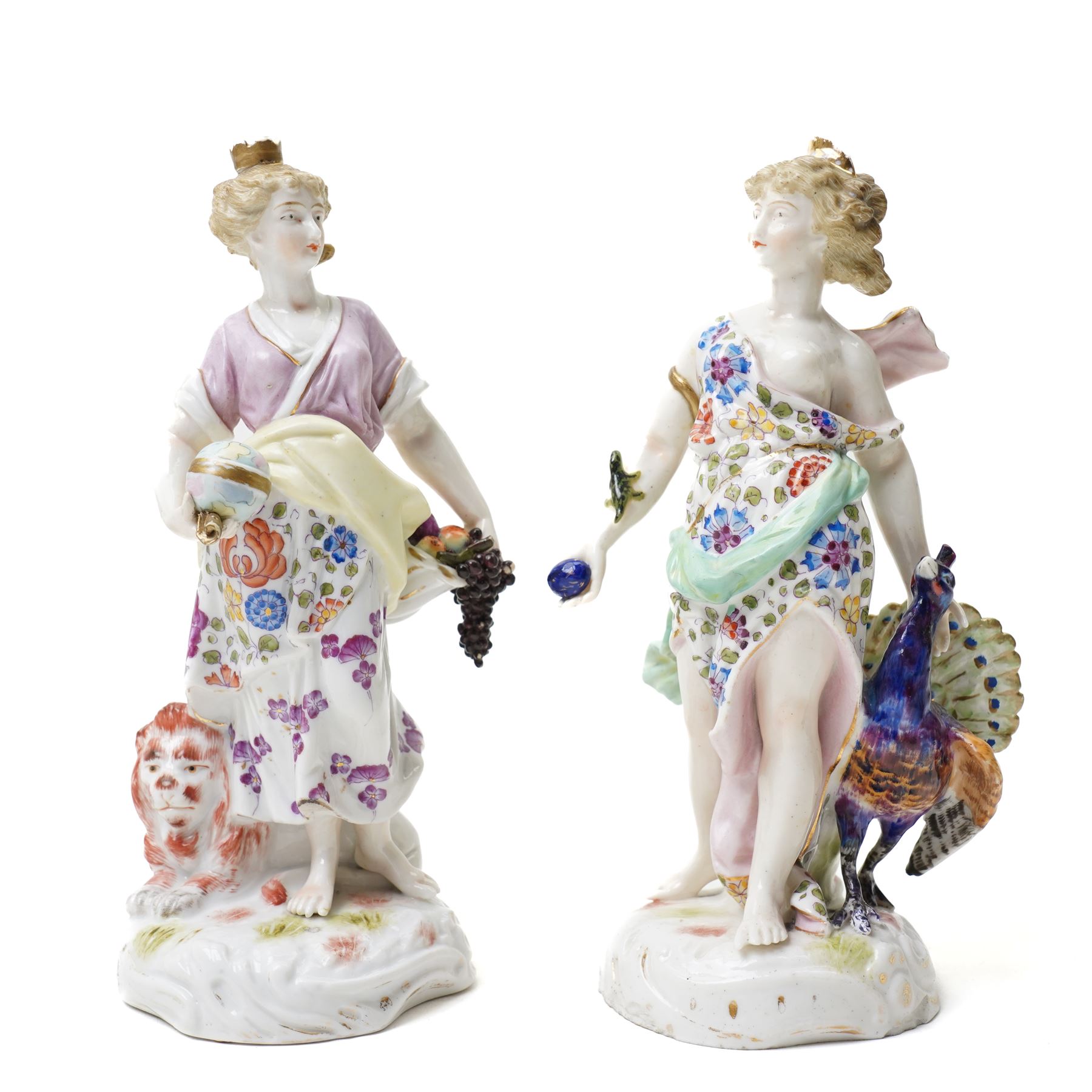 Collection of German and continental porcelain figures, including a figure of Juno with peacock, two figures feeding birds on benches, cherub candlesticks, and others
