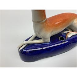 Pair of Staffordshire recumbent greyhound pen holders 