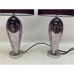 Three lamps, comprising pair with tapered crackled design stems upon chrome bases with purple fabric shades, and a large heavy example with clear glass centre stem with chrome mounts and satin grey shade with gilt interior, H58cm excl shade