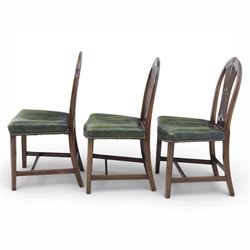 George III style set of six mahogany dining chairs, the arched backs with pierced and carved vase splats beneath carved husk and patera detail, drop-in upholstered seats covered in green leather with brass studded edging, raised on square section legs united by plain stretchers
