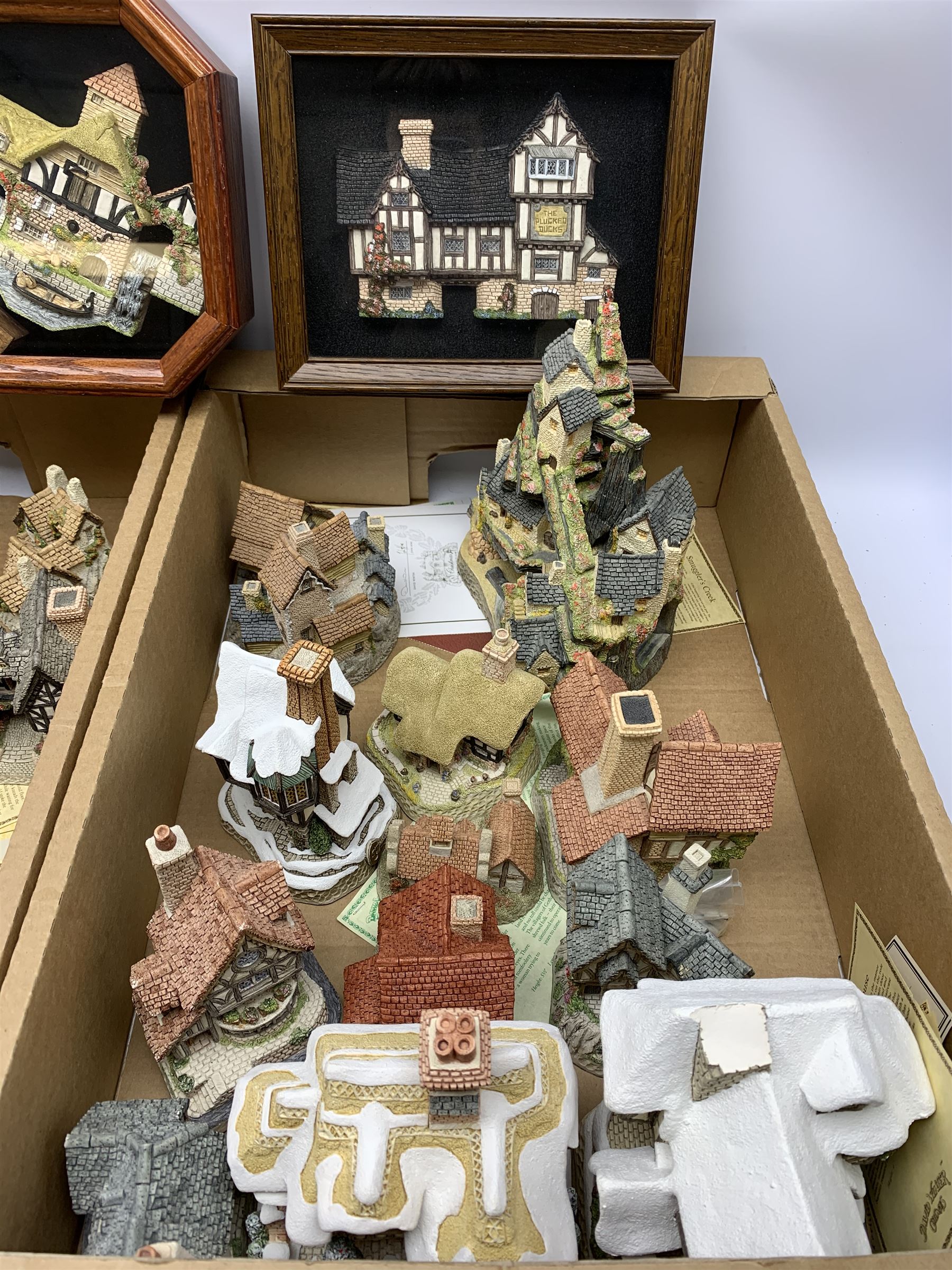 A collection of boxed David Winter Cottages, of various size and form, to include The West Country Collection Smuggler's Creek, Christmas Special 1996 Tiny Tim, Haunted House, Brookside Hamlet, Thameside, Swan Upping Cottage, Miss Belle's Cottage, Tomfool's Cottage, The Candlemaker's, etc., together with two framed fronts, The Plucked Ducks, and Pershore Mill, a number of examples with accompanying certificates. (26). 