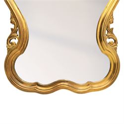 Rococo design gilt wall mirror, shaped and moulded frame, serpentine lower apron, enclosing a plain mirror 