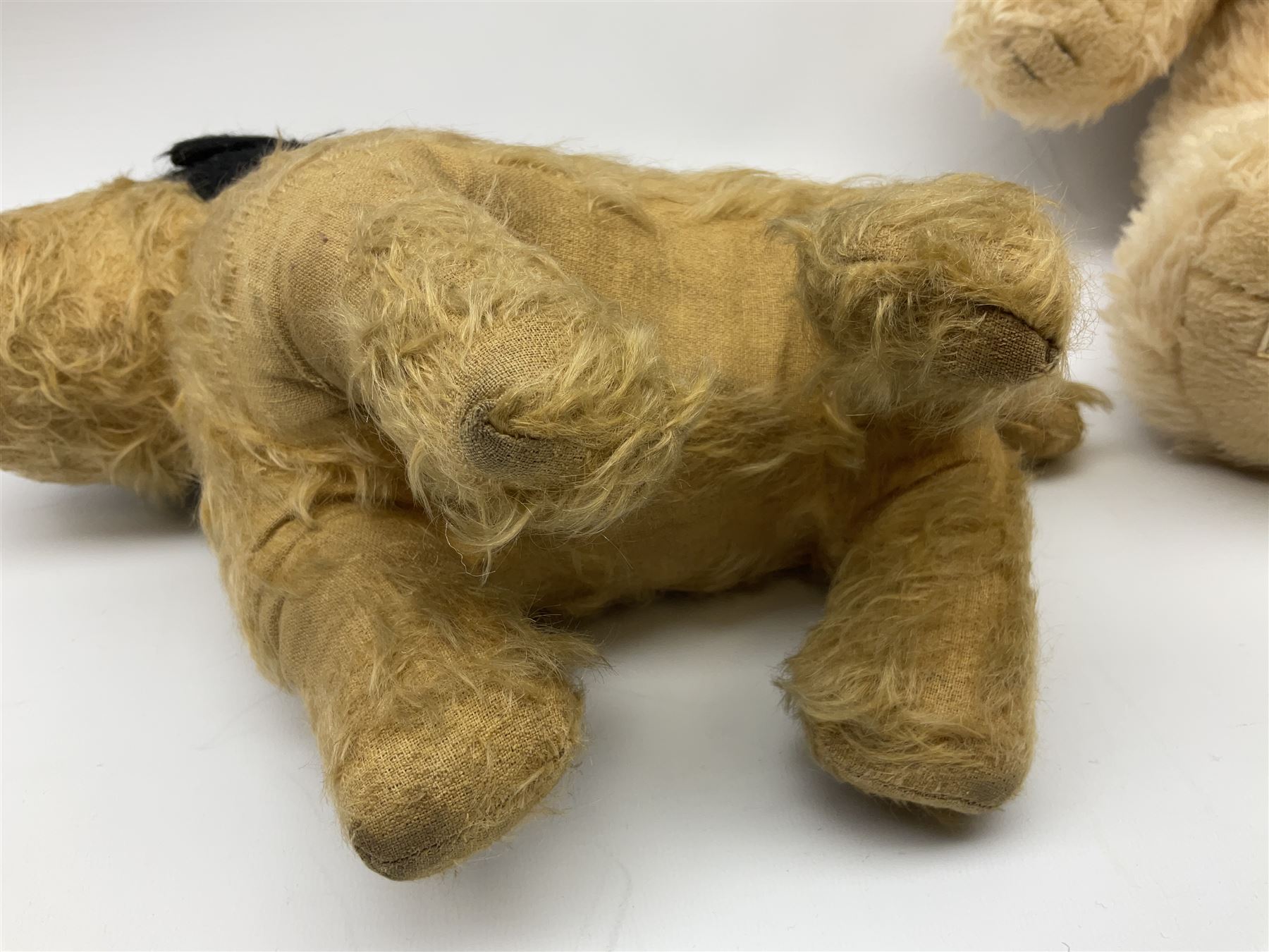 Mid-20th century English plush covered woodwool filled dog with vertically stitched nose and mouth L39cm; and Wendy Boston plush covered teddy bear, the fixed head with applied eyes and vertically stitched nose and mouth H63cm (2)
