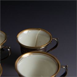 Set of six Lenox porcelain coffee cups, with gilt rims, each with American silver openwork cup holders, stamped sterling