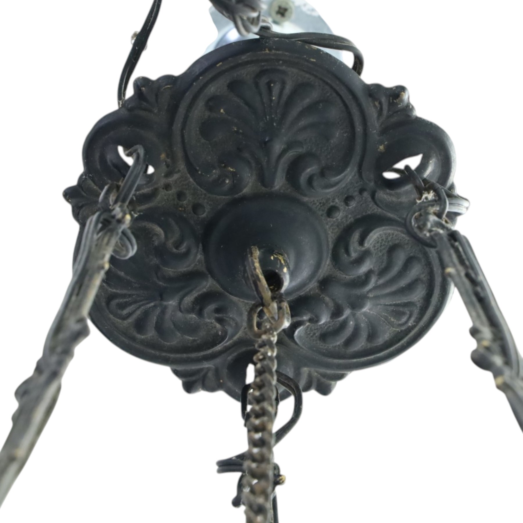 Late 19th century wrought metal hanging ceiling lamp, the ornate pierced central reservoir-form body with mounted eagle, three scrolling branches fitted with three clear glass chimney shades, suspended by decorative chains from a pierced ceiling rose
