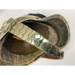 Early 20th century French mounted gendarme's helmet, brass with nickel-silver mountings, broad band embossed with fused grenade, high comb with the face of the gorgon Medusa at the peak and with a black horse hair crest, plume socket at the left, leather-backed nickel-silver chin scales with lion mask mounts.