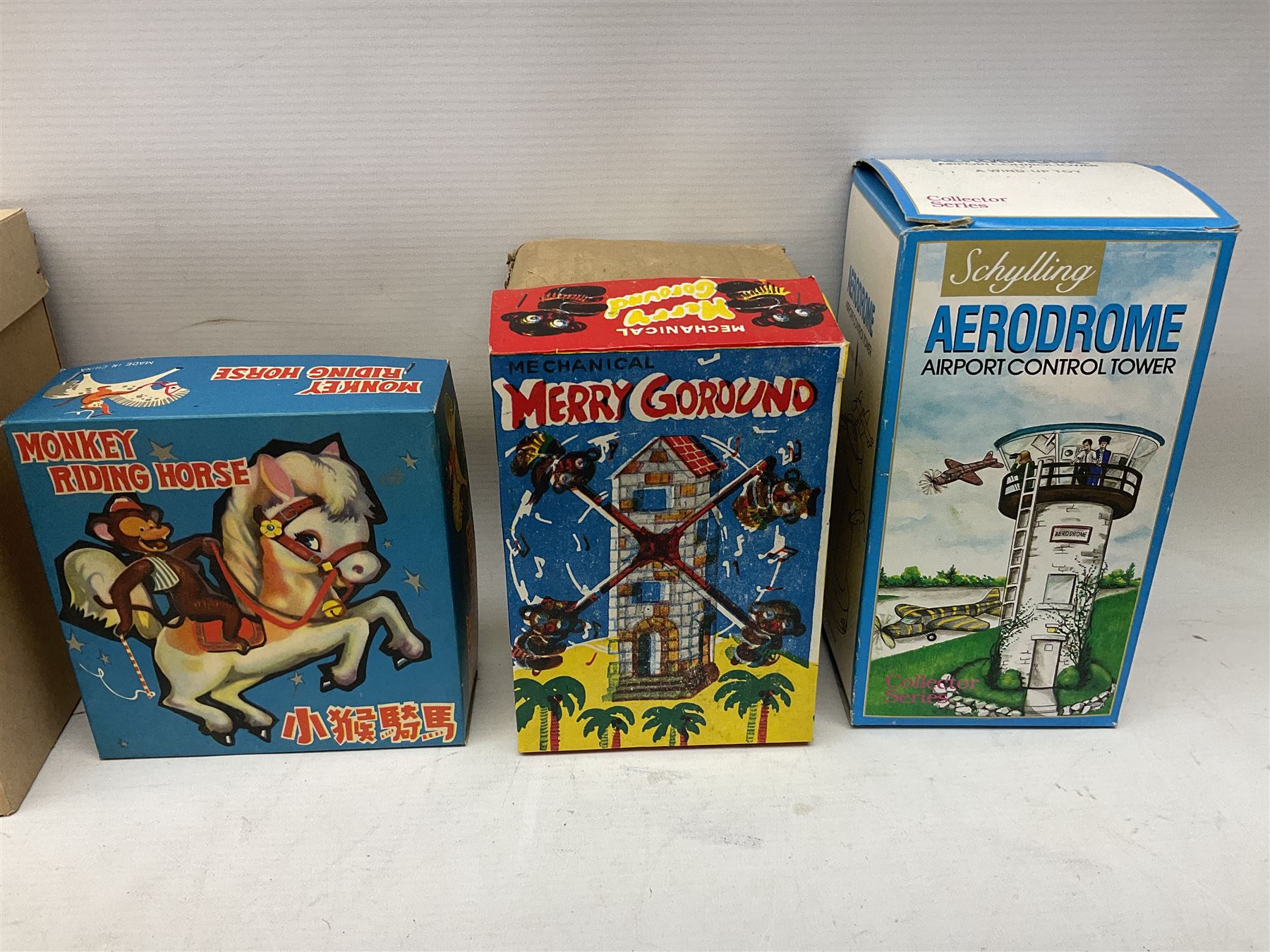 Mid 20th century and later tin plate clockwork toys, to include merry-go-rounds, spaceship carousel, walking robot, Schylling airport control tower, monkey riding horse, astronaut space station etc, including German and Japanese examples, some with boxes (12)