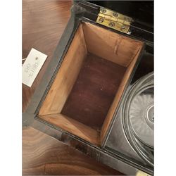 Early 19th century rosewood and brass inlaid tea caddy, of sarcophagus form, the front and hinged opening cover inlaid with brass scrolling panels, opening to reveal a compartmented interior with twin removable boxes with conforming inlaid brass detail to the hinged covers and zinc lining to the interiors, flanking a later glass mixing bowl, the whole upon four turned cylindrical feet, H21cm W36cm D20cm