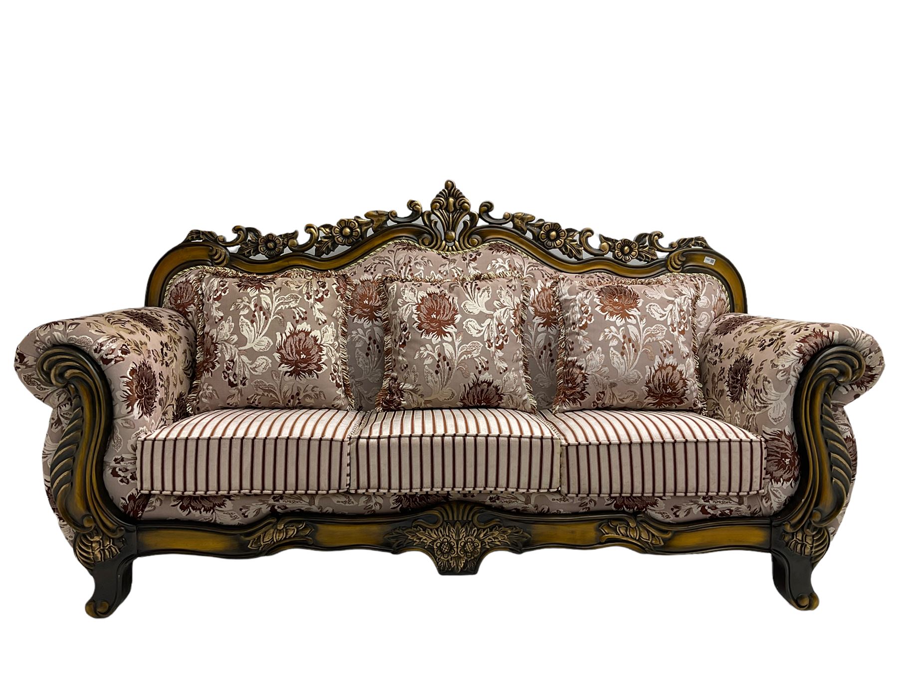 Italian Baroque design three seat sofa, hardwood framed, the cresting rail carved and pierced with c-scrolls and flower heads, scrolled arms, upholstered in floral patterned and striped fabric, with scatter cushions 