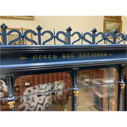 Good quality late 20th century dolls house by M. James dated 1995 in the form of a Beverley East Yorkshire Antique Shop called 'North Bar Antiques'; single-storey single-roomed shop with textured brick walls and flat roof, fully glazed hinged front with recessed hinged customer door and central window to the rear; comprehensively furnished with chests of drawers, pedestal desk, breakfast table, lowboy, two longcase clocks, delft rack with ceramics, occasional tables, pictures, Regency style mirror and collectibles; decorated walls with coving and picture rail and simulated floorboarding; wired for electric lighting; maker's plaque W61cm H42.5cm D41.5cm