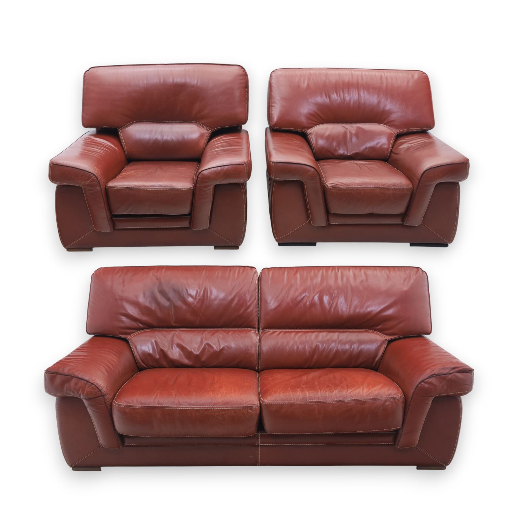 Fabrizio Mantellassi - 20th century Italian red leather suite, one three seat and two large armchairs, upholstered in deep red hide with stitched seam detailing, with magazine pockets to each side, the rectangular back cushions above broad padded arms and seat cushions, raised on low block bases

Sofa: H c98m, W 203cm, D 92cm
Armchair: H 98cm, W 113cm, D 92cm