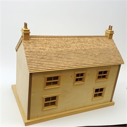 A 24th scale wooden model of a house, or dolls house, with 'tiled' roof, sash windows, and two bay windows to the hinged front, opening to reveal four rooms and two hallways, detailed with kitchen stove and fireplaces, H45cm L54cm D36cm. 
