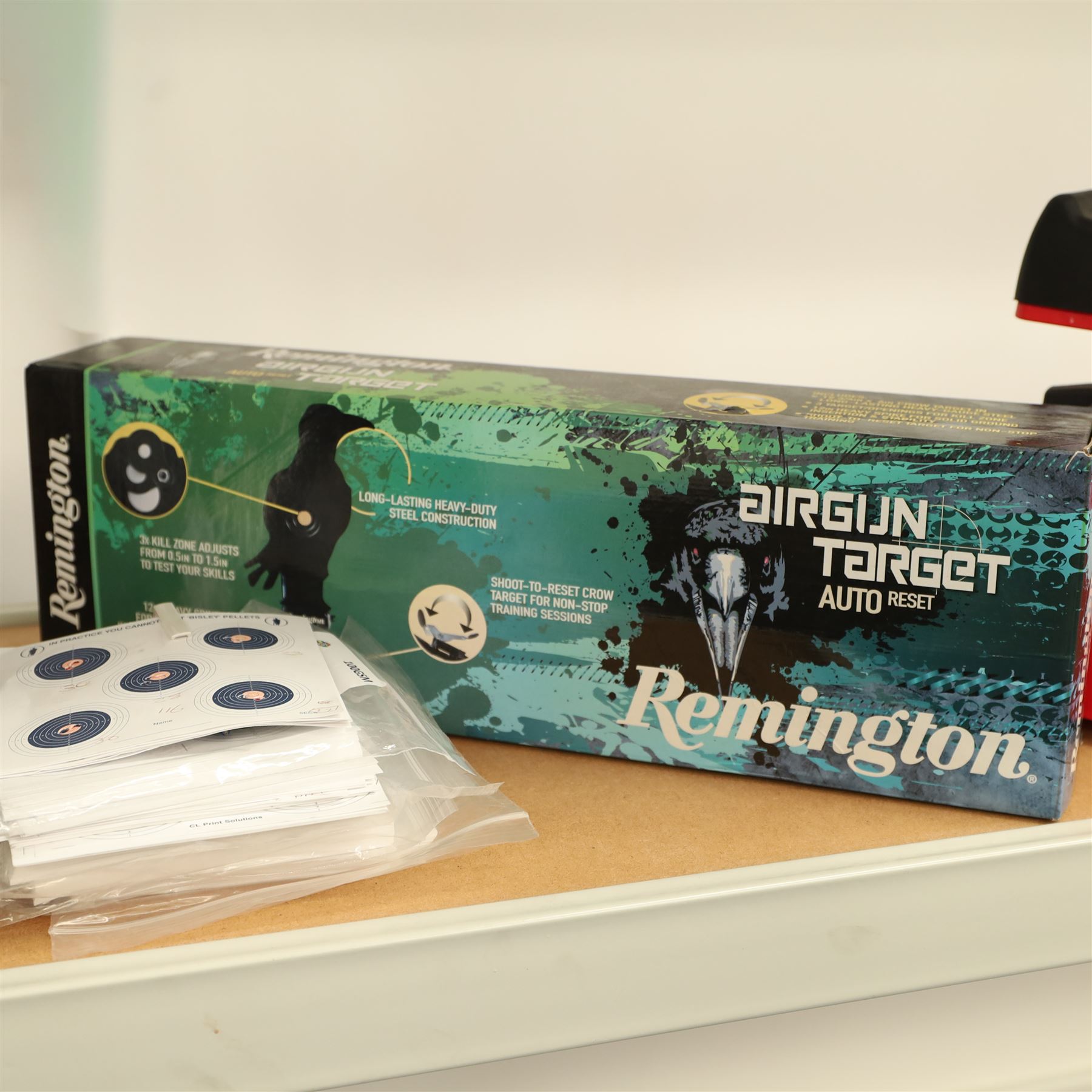 Air gun accessories; Remington Auto Reset crow target, MCM “Predator” shooting rest, paper target holder mounted to a target with additional paper targets