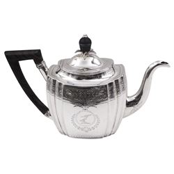 George III silver teapot, of oval form with part faceted sides, wooden handle and finial, the body engraved with central crest and foliate border, hallmarked Duncan Urquhart & Naphtali Hart, London 1799, H16.5cm, approximate gross weight 15.19 ozt (472.5 grams)
