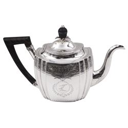 George III silver teapot, of oval form with part faceted sides, wooden handle and finial, the body engraved with central crest and foliate border, hallmarked Duncan Urquhart & Naphtali Hart, London 1799, H16.5cm, approximate gross weight 15.19 ozt (472.5 grams)
