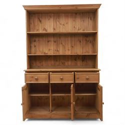 Late 20th century pine kitchen dresser, the upper section with open shelves and tongue and groove back, over a triple cupboard base with three drawers, turned wooden knobs throughout