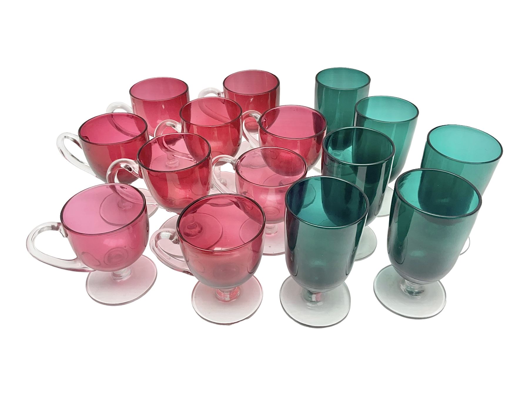 Collection of 19th century coloured glasses, to include nine cranberry glass punch cups, each with clear glass handle and foot and a set of six green glasses, with short clear stems, tallest H10cm