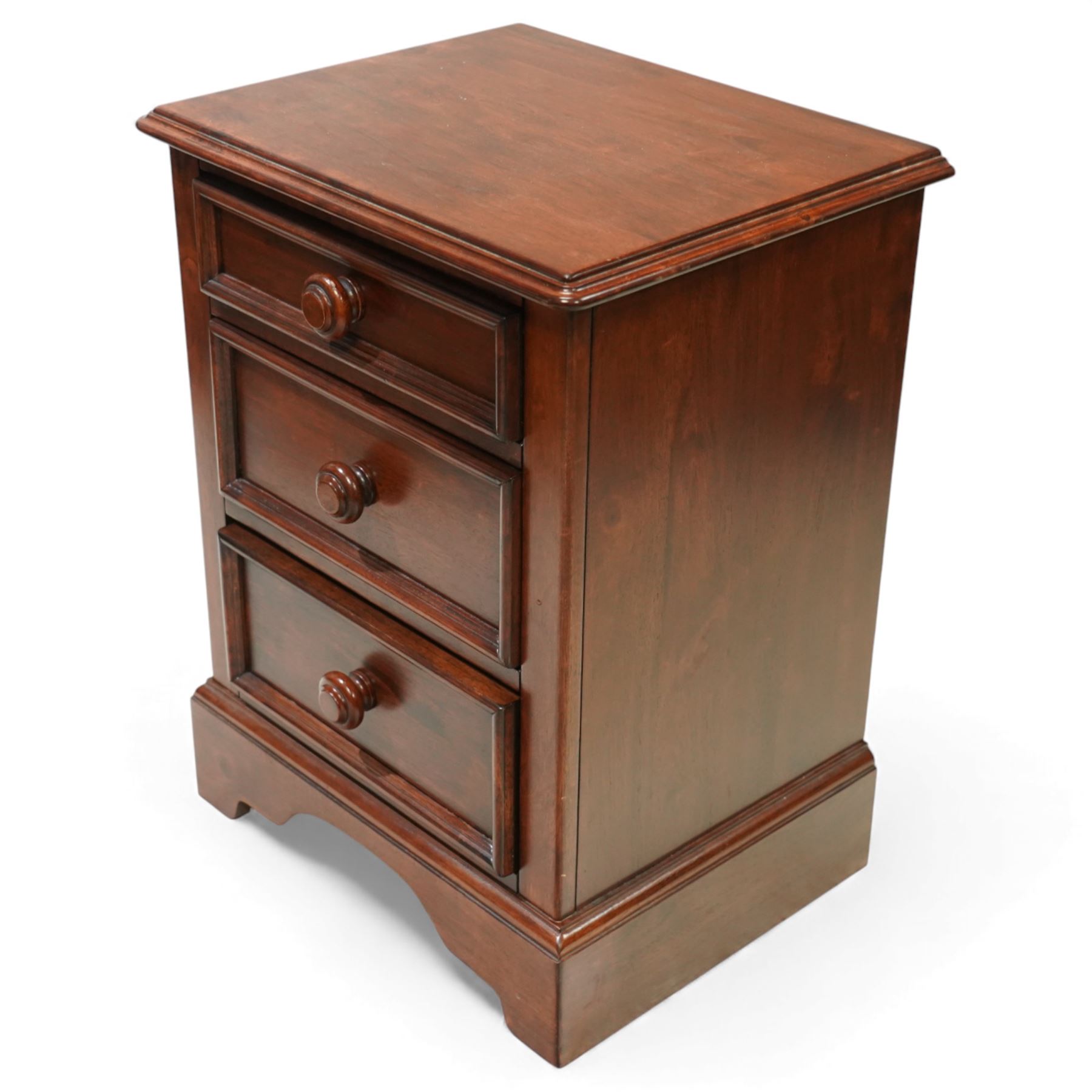 Willis & Gambier - three-drawer lamp chest, rectangular moulded top over three framed drawers with turned wooden knobs, raised on a shaped plinth base