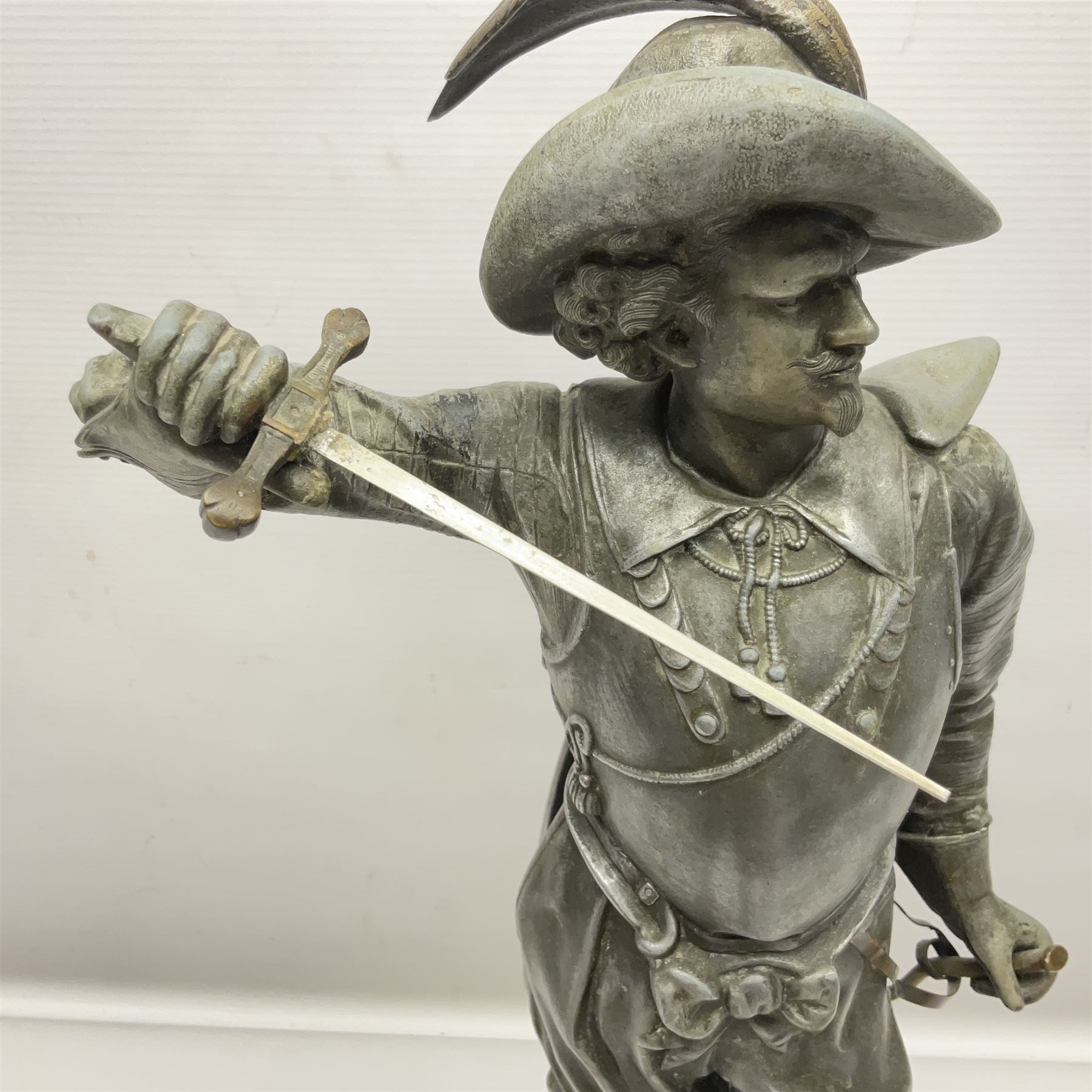 Spelter figure modeled as Cavalier with a raised sword, upon a circular base, H52cm