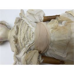 Victorian wax shoulder head doll with pale complexion, applied hair, inset glass eyes and fabric covered jointed body with kid leather lower arms; white linen dress and undergarments H50cm