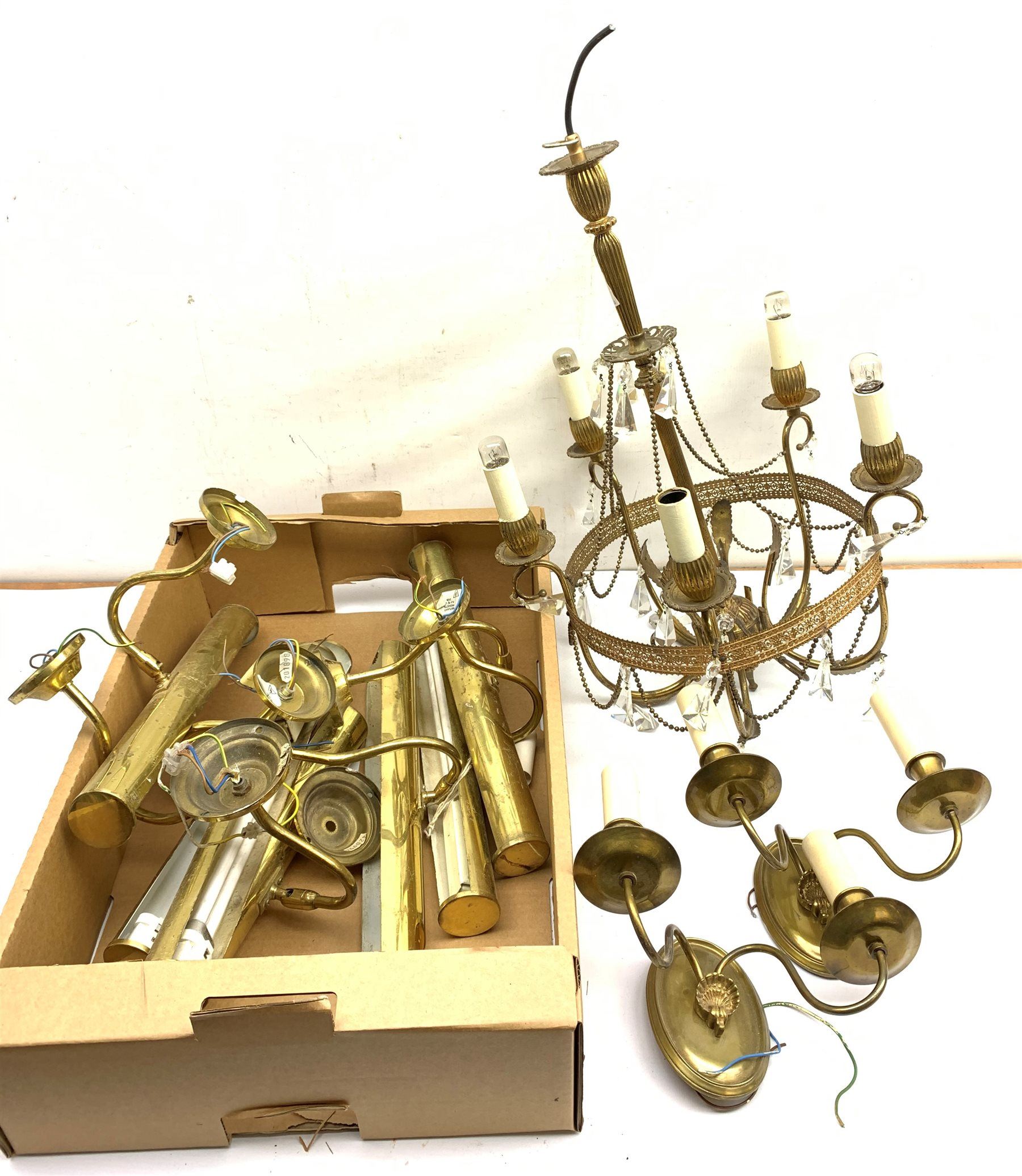 A gilt metal chandelier with five scroll branches supporting glass droppers, H56cm, together with seven brass picture lights, and two twin branch wall sconces. 