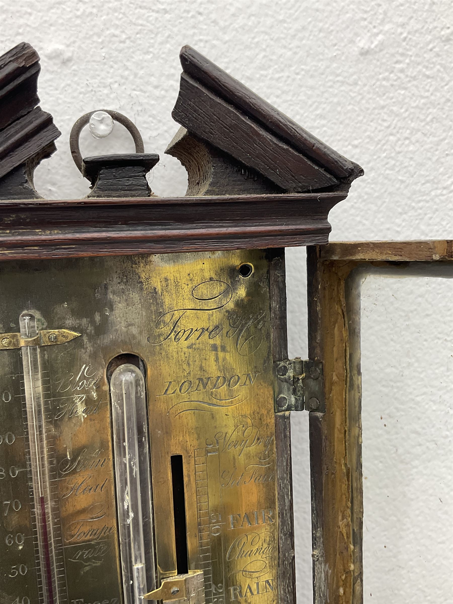 William IV mahogany stick barometer signed “Torre & Co, London”, with an architectural broken pediment above a glazed door, exposed mercury tube with glass bulb cistern behind a turned mahogany cover, engraved register plate with a scale from 27” to 31” with a manual vernier and spirit filled thermometer from zero to a hundred degrees fahrenheit, engraved with the makers name and weather predictions. 
Torre & Co are recorded as Barometer manufacturers, Leigh Street, Red Lion Square, London c1830.
