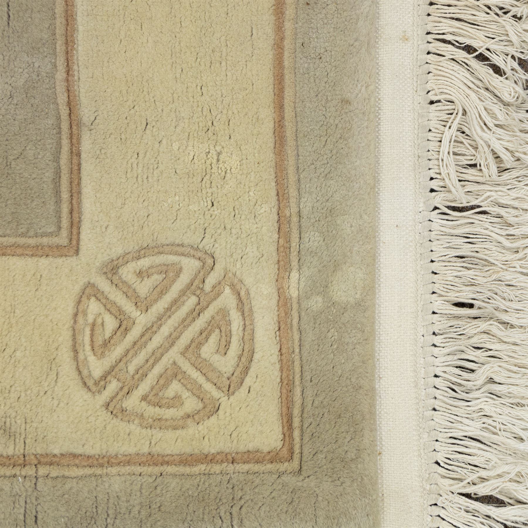 Chinese wool rug, the pale grey central field decorated with two stylised dragons, flaming pearls and cloud scrolls, within a cream border of shou medallions and geometric motifs, with cotton fringe ends